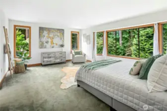 Inviting primary en suite with more gorgeous green views overlooking the backyard sanctuary.