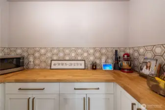 Butler's pantry with tons of outlets, butcher block countertop and tons of storage.
