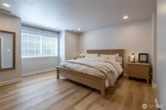 Large primary bedroom, with en suite bath and walk in closet.