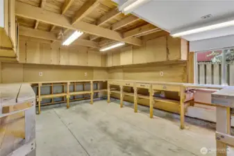 Workshop features cabinets, workbenches and plenty of electrical outlets.