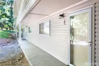 Enter your home from the carport up one flight of stairs and amongst the trees.