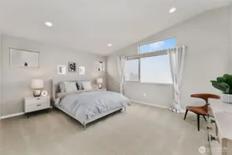 stunning primary bedroom with vaulted ceilings