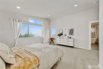 stunning primary bedroom with vaulted ceilings