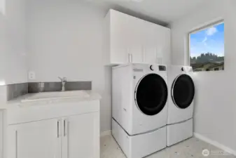 laundry with cabinets and deep sink!