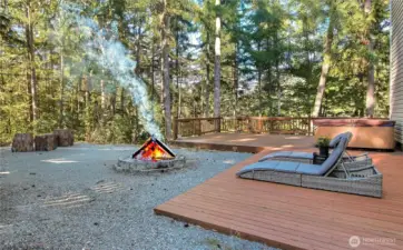 View of your back/side yard, fully fenced, huge deck and no maintenance stone throughout, included hot tub and the views! Lake and territorial views abound.