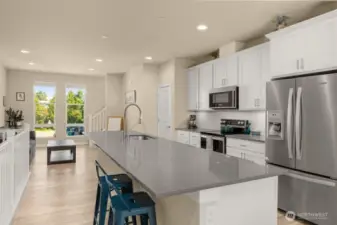 Designed for both function and style, the open-concept main level boasts quartz countertops and generous storage throughout, including a walk-in pantry you’ll love.