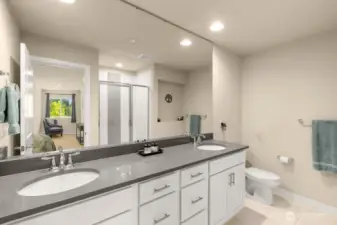 Dual vanity sinks and beautiful tiled shower with high-end finishes throughout.