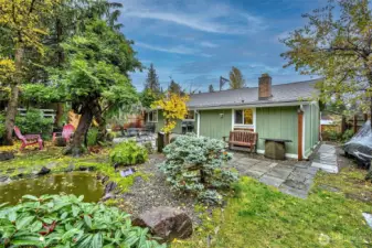 Backyard Patio Area All Professionally Landscaped With Pond And Walking Trails.