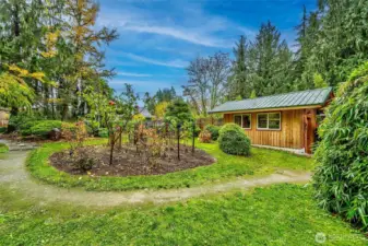 Backyard Area Showing Detached Shop, Fruit Trees, Raspberry Garden, And Walking Trails.