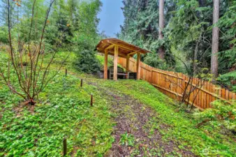Lighted Walking Trail Leads Down To The Lower Backyard Area w/Sitting Area.