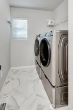 Second floor utility room with newer front loading washer and dryer.