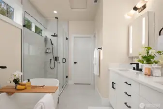 The walk-in closet at the end of the primary bath has custom shelving.