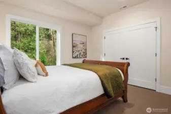 The 2nd upper level bedroom looks out to nature.