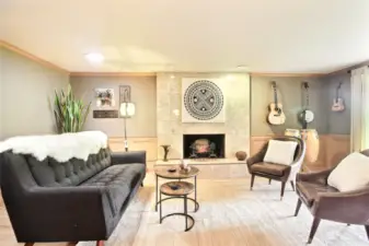 The formal living room has a charming fireplace, overlooks front patio.