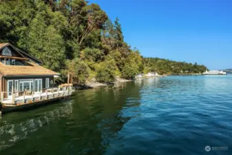 This charming home sits right down on the water with 170 feet of shoreline. Solar panels on the roof capture the all-day sunshine.