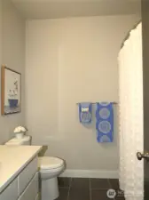 GUESTS WILL ENJOY THE FULL BATH WITH WHITE VANITY & SHOWER/TUB COMBINATION!
