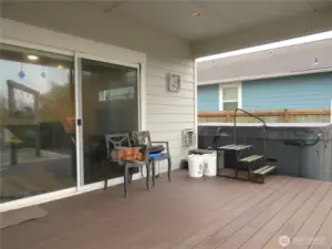 OUTSIDE THE GREAT ROOM IS THIS FULL TREX COVERED DECK! THE STEPS LEAD TO A LAP POOL!