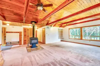 Another view of the Living Room with the entrance on the left and hallway to the bedrooms just to the right of the wood stove.