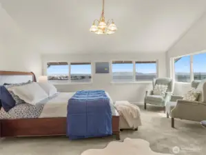 The primary bedroom is located on the upper level where picturesque views stop you in your tracks as you enter.