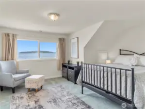 Bedroom number two is on the upper level, overlooking the expansive views. In addition to the closet, there's a large storage space to the left of the bed.