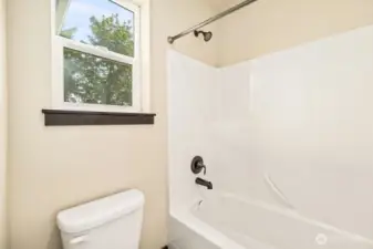 Separate space for toilet and tub.