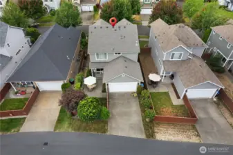 Private extended back patio with a side yard that features a rose and vegetable garden.