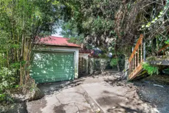 Detached garage (left) and storage shed (right) needing restoration or removal.