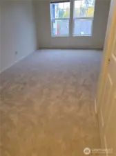 Primary bedroom.  Closets on the right; exit to the left.  Bathroom behind photographer.