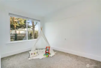 The front bedroom—ideal for guests or a work-from-home office—features freshly cleaned carpet, fresh paint, and a sunny window with updated coverings.