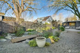 Mature trees surround the lot, providing privacy, natural beauty, and cooling shade during the summer months.