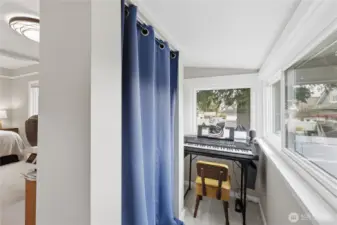 On the other side of the wall is a mini room used as a music room.