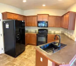 Kitchen that opens into living/dining areas