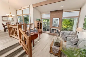 Large windows and fireplace in lower living room.