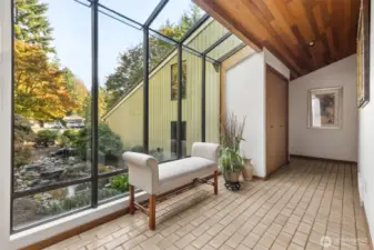 Front entrance foyer looks onto garden pond.
