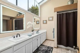 Hallway bathroom with wall/ceiling windows for great morning light.
