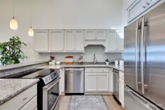 Beautifully updated kitchen features nice views, granite counters and stainless appliances.