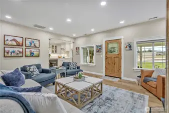 Living room with front entry looking toward the kitchen