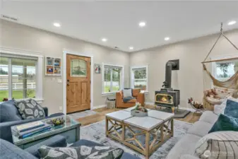 Entry into living room with cozy wood stove that heats entire home