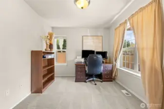Den/ office with double French doors to right of entry way.