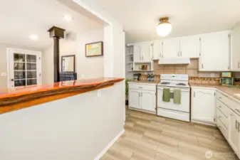 Fully equipped and filled with warmth, this kitchen blends cottage comfort with thoughtful touches—like butcher block counters, open shelving, and that handcrafted live-edge bar. Guests will feel right at home as they cook, connect, and unwind.