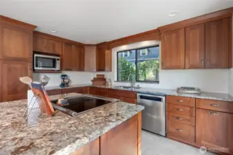 Beautiful countertops paired with an abundance of natural light create an elegant and inviting atmosphere in this stunning kitchen.