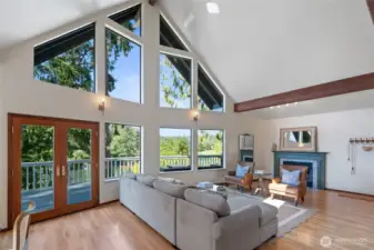 Expansive vaulted floor-to-ceiling windows frame stunning views of Whiteman Cove, seamlessly bringing the beauty of the outdoors in.