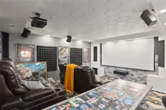 On the other side of the rec room, you'll find the media room of your dreams!  Built in speakers, projector and retractable screen.