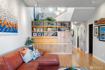Built-in bookshelf features a hidden wet bar. Plenty of room to store barware behind the tambour doors.