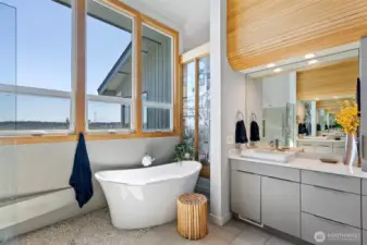 Soak in the tub while enjoying the stained glass art wall.