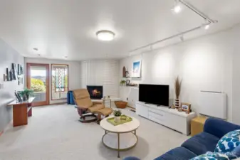 Downstairs is the second living space, featuring the third fireplace and access to the lower deck.