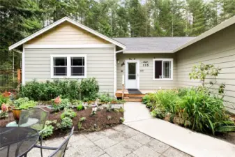 Front garden has been meticulously cared for, and is full of spring-blooming bulbs and perennials, making for a bright and colorful garden, perfect for morning coffee or entertaining guests.
