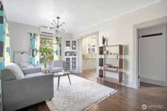 Spacious living room with original fir floors and high ceilings.
