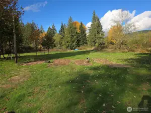 Large flat area at the back of the property, potentially for home location or ADU if approved by county. Buyer to research feasibility.