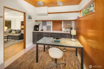 This cool lower level flex space has extra high ceilings and a warm wall of wood.